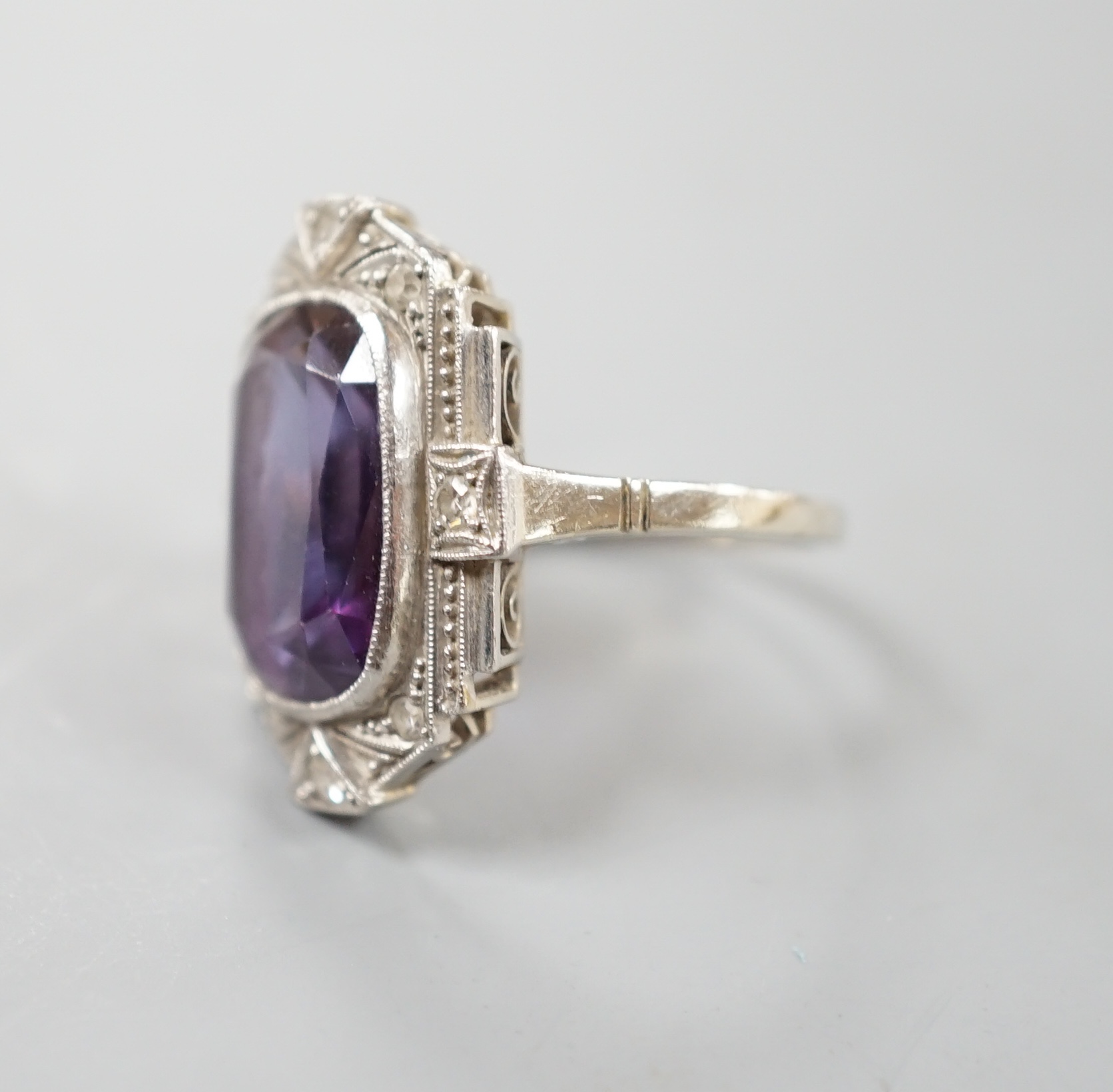 An Art Deco style white metal, synthetic colour change corundum and diamond chip set dress ring, size L/M, gross weight 5.6 grams.